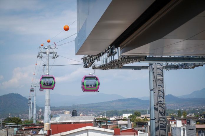 Pese a 4 suspensiones definitivas y un asesinato, se inaugurará el Teleférico de Uruapan El hombre murió al instante al recibir la descarga de un arma en el corazón frente a 3 de sus hijos que lo esperaban para abordar el vehículo que manejaba; veía a uno de ellos a los ojos cuando un motociclista, con casco y pasamontañas, lo asesinó a sangre fría. Era Isidro Ramos Sandoval, el abogado que obtuvo 4 suspensiones definitivas contra la construcción del Teleférico en Uruapan, eran cerca de las 14:30 horas del sábado 29 de marzo del 2025. Habían pasado exactamente 7 días de que decenas de policías estatales irrumpieron en el fraccionamiento Bosques de Uruapan, en el que Isidro Ramos encabezaba la Asociación de Colonos; uno de los uniformados trepó el portón y permitió el ingreso del resto. Inconformes con la instalación de una de las torres del Teleférico en pleno complejo habitacional, los vecinos manifestaron su inquietud con la obra desde el 2023 cuando se conoció del proyecto de la obra a cargo de la empresa austriaca Doppelmayr Group en alianza con Grupo INDI, ganadores de la licitación, con una inversión de 3 mil 200 millones de pesos. A prácticamente 13 meses del asesinato de su esposo, María de la Luz Ortiz Sandoval recuerda que el abogado tardó prácticamente un año estudiando los efectos que tendrían los trabajos en el suelo y subsuelo, donde “había mucha agua”; advertía que no era algo muy estable. Tras análisis y estudio, accedió a la petición de sus vecinos y decidió proceder “con la ley en la mano”. “Los residentes de la mayoría de los residentes de Bosques de Uruapan son los que él siendo en ese momento el presidente del fraccionamiento y también como abogado le pidieron su asesoramiento y apoyo. Y pues él este lo hizo pues para proteger en este caso nuestro parque y proteger este, decía él toda que nuestra fauna que nosotros teníamos y los mantos acuíferos que también se manejan de manera subterránea que hay y que va a haber un daño estructural”. Isidro Ramos promovió el amparo número 6/2025 contra la construcción del Teleférico en el área verde del fraccionamiento y obtuvo la primera suspensión definitiva el 21 de octubre del 2024. En los siguientes meses promovió 3 amparos más: el 798/2024, 787/2024 y 67/2024, en todos obtuvo la suspensión provisional y luego definitiva, que estaba vigente hasta el momento de su homicidio. Los jueces a cargo determinaron que “MANTENGAN LAS COSAS EN EL ESTADO QUE ACTUALMENTE GUARDAN” y ordenaron: 1-No afectar el bosque (tala de árboles) del fraccionamiento privado "Bosques de Uruapan” y “no se realicen ahí obras de construcción de la cimentación e instalación de una Torre del Sistema de Transporte por Cable (Teleférico).” 2- No continuar con los trabajos de excavación, cimentación e instalación de las Torres enumeradas con los arábigos 44, 45 y 46”, en el entorno adyacente del Parque Nacional "Barranca del Cupatitzio" y el "Lago de la Cruz Roja" o "Laguito de los Patitos", de Uruapan. 3- No se afecten los árboles (derribo, poda o transplante) que se localizan en el entorno adyacente y del Parque Nacional "Barranca del Cupatitzio. 4- Detener la construcción del Teleférico en el trazo que conecta la Estación Centro ubicada en Calle Álvaro Obregón número 43, con la estación 6 localizada en el Mercado Zona Poniente, situada en Avenida La Huerta, colonia La Quinta, ya que atraviesa el centro de la capital y en la zona con mayor concentración de Monumentos Históricos. Se argumentó que el proyecto no era sustentable, que había omisión de autoridades al no suspender la construcción de 47 torres y 6 estaciones del Teleférico cuando no tenía licencia de construcción, ni tenía estudios, permisos, dictámenes, autorizaciones y planos. En los escritos se señalaron 11 autoridades y empresarios responsables, entre ellos el gobernador de Michoacán, la Secretaría de Desarrollo Urbano y Movilidad del estado y la Secretaría de Comunicaciones y Transportes, con residencia en México, además de las empresas Doopelmayr México y Gammi Ingeniería e Instalaciones. Aunque existían 4 amparos con suspensiones vigentes, la viuda del abogado recuerda que prevalecía la intimidación hacia los vecinos, sino era un notario, era un funcionario que acudía a medir el terreno, en el que insistían en colocar la torre del Teleférico en plena zona verde Del fraccionamiento. “Estamos hablando de cuatro amparos que los cuatro amparos fueron promovidos por mi esposo al licenciado Isidro Ramos Sandoval y que a todos les dieron la suspensión, entonces este suspensión que realmente fue violentada”, recordó la viuda del abogado. LA NEGOCIACIÓN CONTRA LOS AMPAROS Uno de los más insistentes en la negociación con los vecinos, fue el subsecretario de Gobernación, Juan Daniel Manzo Rodríguez, quien en febrero citó a una reunión de colonos para insistir que se permitiera la edificación de la obra, junto con la anterior presidenta de vecinos. En el audio en poder de este medio de comunicación, el funcionario advierte que la construcción de las torres no se va a detener y que los amparos promovidos no frenarán los trabajos. Juan Manzo: “La verdad es que ninguno (amparo) ha detenido las torres. Y menos éste, que es un predio estatal, menos donde ese del estado, a lo mejor alargan el tema dos tres meses, con más conflicto, como sea, pero creo que no conviene resolver este asunto con una mala relación con el gobierno del estado”. Vecina: “Como con los granaderos”. Juan Manzo: “No, es que no hay necesidad, si es acordado los vecinos ganan”. El funcionario les aclaró que por cuestiones técnicas las torres no podían cambiar de lugar. Incluso les advirtió con promover una queja contra funcionarios del Poder Judicial que vivían en ese complejo y habían “cabildeado que los amparos procedan”; pero además ofreció ceder el predio donde se ubicaría la torre en comodato para el fraccionamiento. “También sabemos que, indebidamente, funcionarios que viven aquí del Poder Judicial han estado cabellando en que procedan estos afrontes. Están plenamente identificados y se va a presentar una queja ante el Poder Judicial. Porque eso es tráfico de influencias y es conflicto de interés” LA ACCIÓN POLICIAL El 22 de marzo del 2025 se registró una de las irrupciones violentas al fraccionamiento Bosques de Uruapan; decenas de policías tomaron por asalto el lugar e ingresaron trepando por el portón principal, permitiendo así que personal de la empresa constructora derribara los árboles de la zona verde y también algunas bardas. Las imágenes dieron la vuelta al mundo en redes sociales, ya que se aprecia el derribo de los árboles, el grito de los colonos y la acción policial. Luego de lo ocurrido ese sábado, el secretario del presidente municipal de Uruapan, Carlos Manzo Rodríguez buscó al abogado para que se reuniera con el alcalde; acompañado por otros vecinos Isidro acudió a la cita a la Casa de la Cultura donde nunca fue recibido por el munícipe el 25 de marzo del 2025. Su viuda recuerda que fueron dos abogados quienes los recibieron, mientras Manzo solo escuchaba un poco más atrás, sin recibirlos ni entablar comunicación. “Estas personas no tenían el conocimiento de lo que realmente eran los amparos y cómo funcionaba todo eso no tenía ningún conocimiento y si lo vio porque ahí estaba sentado en una sillita dicen que una mesita donde solamente estaba escuchando todo lo que se hablaba pero nunca tuvo la atención de ir personalmente a hablar de frente con mi esposo”. Pese al encuentro con los abogados municipales, el jueves 27 nuevamente llegaron máquinas y personal del ayuntamiento con policías con los que intentaron de nuevo ingresar al fraccionamiento. Con notario, intentaron poner la malla ciclónica y delimitar el área donde se construyó finalmente la torre. EL FINAL Dos días después, el sábado 29, Isidro Ramos llegó a recoger a 3 de sus hijos a una de las farmacias en las que trabajaban; manejaba su vehículo y cerca de las 14:30 horas se detuvo para que subieran. Pero una moto lo iba siguiendo y al momento de bajar el cristal para ver a su hijo de 11 años, el homicida metió la mano y le disparó en el corazón, su muerte fue instantánea. Su viuda acudió a los dos días a interponer la denuncia por el homicidio de su marido sin dudas, con nombre y apellidos: contra el gobernador Alfredo Ramírez Bedolla, el entonces presidente municipal de Uruapan, Carlos Manzo Rodríguez y el subsecretario de Gobernación, Juan Daniel Manzo Rodríguez. “Mi esposo no tenía ningún tipo de problema con nadie, las únicas situaciones que él siempre manejaba y lo que tenía literalmente de un año hacia atrás de un año y medio hacia adelante, únicamente trabajaba para estos amparos y lo único que él hablaba y todo era de los amparos y las situaciones que había por medio de las autoridades encargadas. Yo dejé en mi denuncia como responsables al gobernador Alfredo Ramírez Bedolla a Carlos Manzo, a Juan Manzo”. A la fecha, María de la Luz Ortiz Sandoval nunca ha sido llamada a declarar sobre el caso, ha sido como si no hubiera ocurrido porque nadie habla del asesinato del abogado. Dos días después el entonces Fiscal Adrián López Solís informó en Casa de Gobierno que habían identificado al asesino y que “cuadraban” la circunstancia del crimen, solo eso. Luego del homicidio de Isidro Sandoval, ningún abogado aceptó dar seguimiento a los amparos por temor ante lo ocurrido, por lo que prácticamente quedaron sin efectos. Su viuda explica que se promovieron incidentes sin que nadie conteste, por lo que se considera ya revocada la suspensión. “Posteriormente a que le quitaron la vida este a mi esposo nadie ha querido trabajar en estos casos, nadie ha querido seguir con los amparos por obviamente miedo por la represión que vivimos este y pues absolutamente nadie ha querido trabajar en ello entonces se han tenido que litigar solos, han presentado incidentes y obviamente como no ha habido réplica pues este ya los amparos este entiendo que hasta julio ya este quedó revocada la suspensión porque pues no ha habido más que quien pueda debatir que se tenía razón en lo que se dice” Sin embargo, sólo el 798/2024 tiene una sentencia, el amparo se declaró sobreseído el primero de octubre del 2025 ante la ausencia de una parte quejosa con interés legítimo. Los otros amparos siguen sus procesos sin tener una sentencia; en el 787 del 2024 se promovieron 154 incidentes desde que fue presentado, el último del 6 abril del 2026; en el 67/2025 el último trámite se realizó el 30 de junio del 2025 y en el 6 del 2024, el último incidente se promovió en 14 de enero del 2026, para hacer referencia al fallecimiento del promovente, sin que se anexe ningún otro dato. El Teleférico será inaugurado este 18 de abril, a 1 año, 1 mes y 20 días del asesinato del abogado Isidro Sandoval Ramos; sus torres fueron colocadas en espacios públicos sin importar que obstruyan avenidas, accesos a comercios, estacionamientos o viviendas particulares. El abogado contemplaba presentar una queja ante la Comisión Nacional de Derechos Humanos, pero tras entrevistarse con los representantes de Carlos Manzo, le solicitaron esperar al lunes siguiente, es decir, el 31 de marzo; Isidro Sandoval estaba muerto para entonces, un desconocido le arrebató la vida.